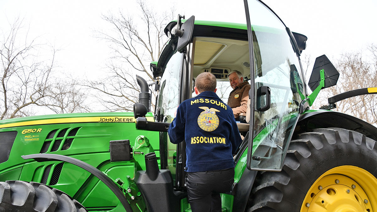 riding with Gov. Mike Parson in a tractor